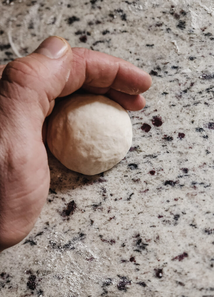 Shaping naan dough into balls