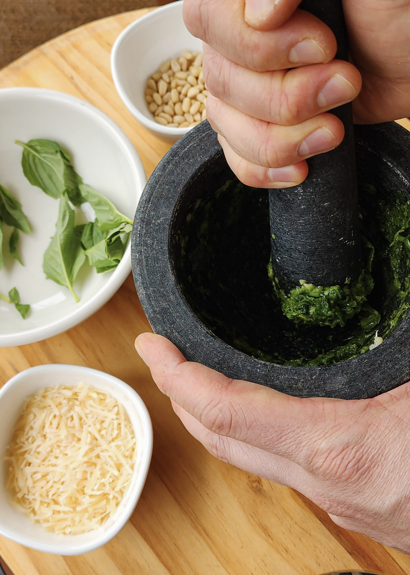 Using a pestle and mortar to make pesto.