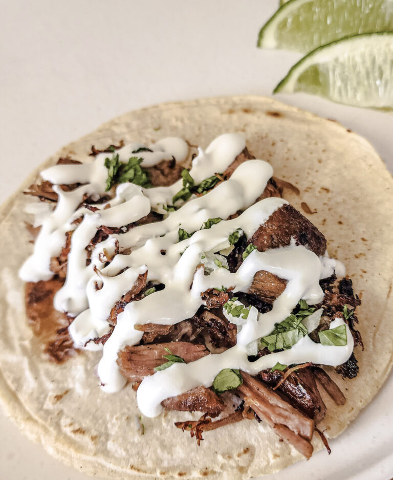 Mexican crema drizzled over a carnitas street taco.