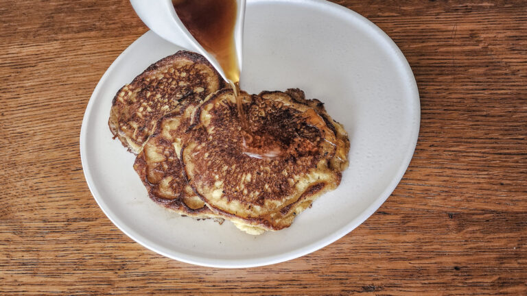 Pouring syrup over pancakes