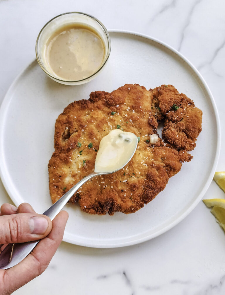 Drizzling lemon cream gravy over chicken