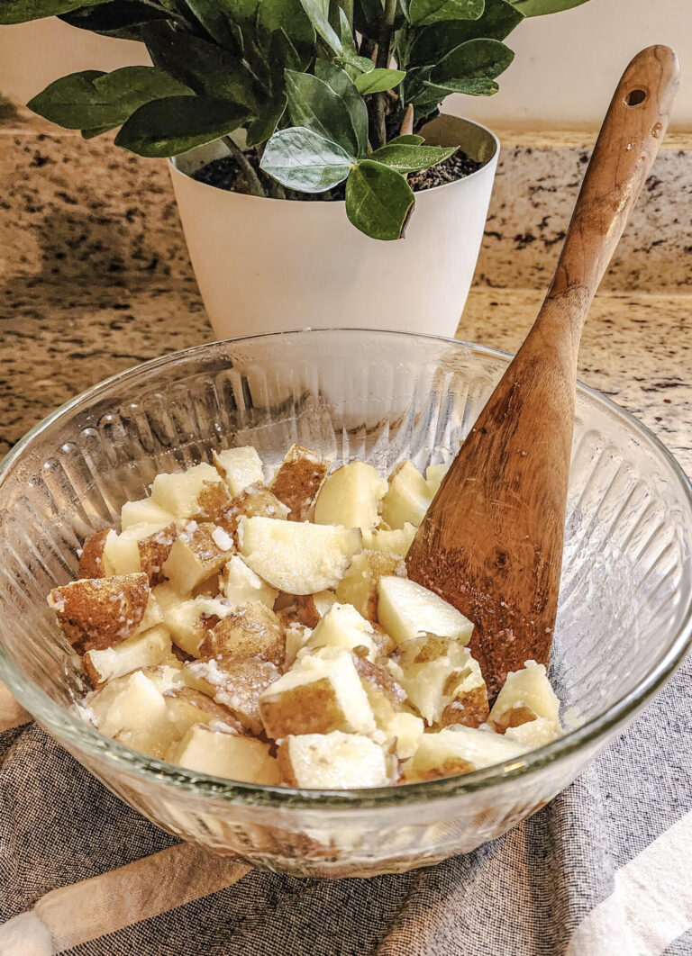 Tossing the potatoes and oil before roasting.