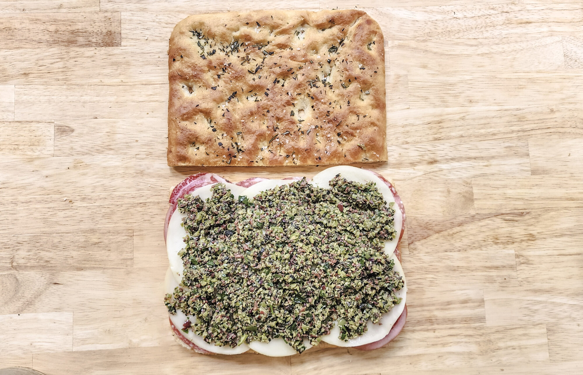 Olive tapenade spread over Muffuletta