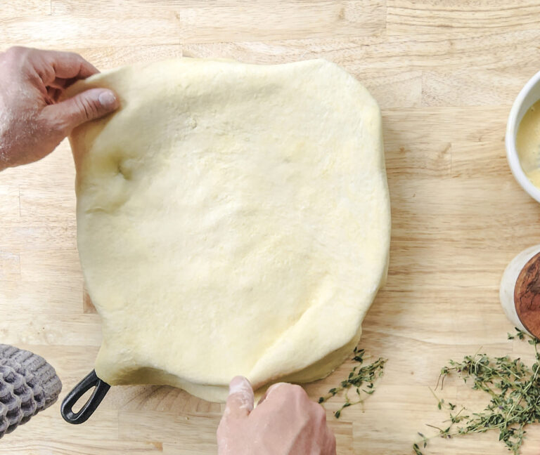 Placing crust over chicken pie