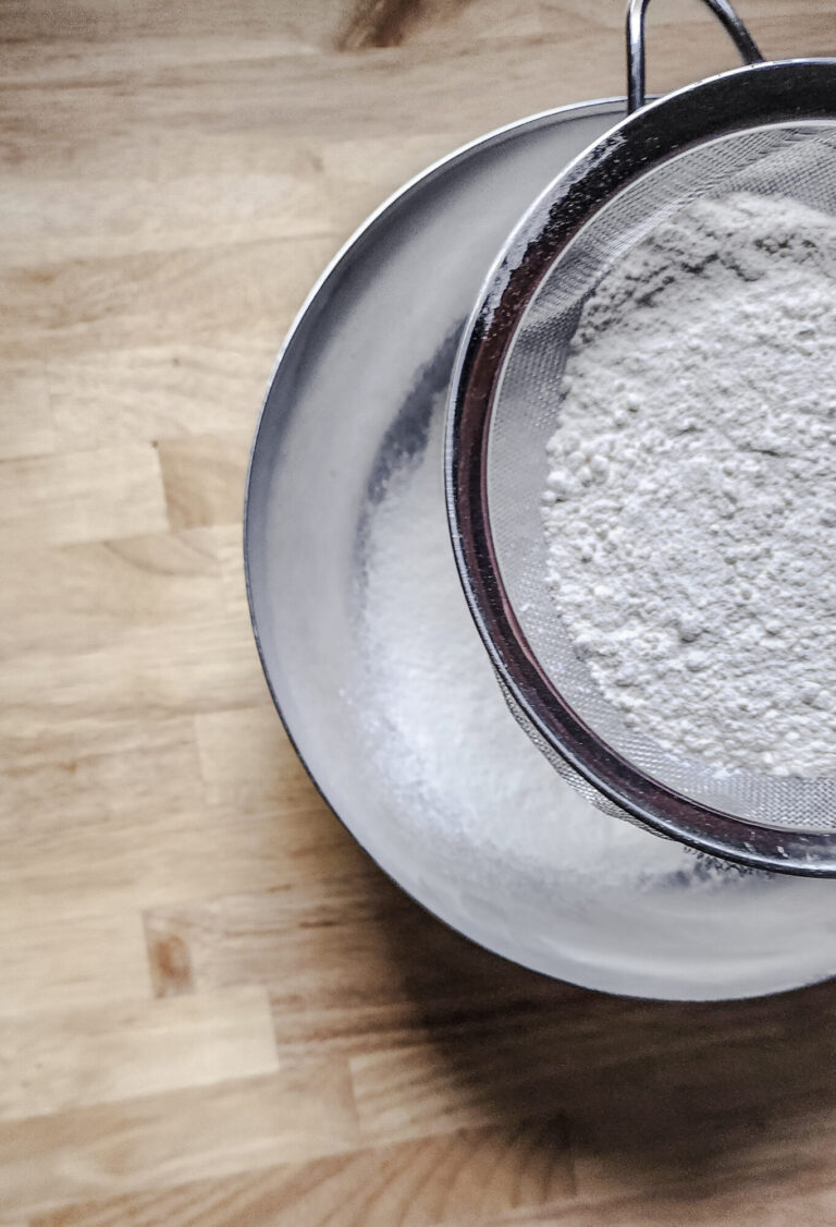 Sifting ingredients for buttermilk biscuits