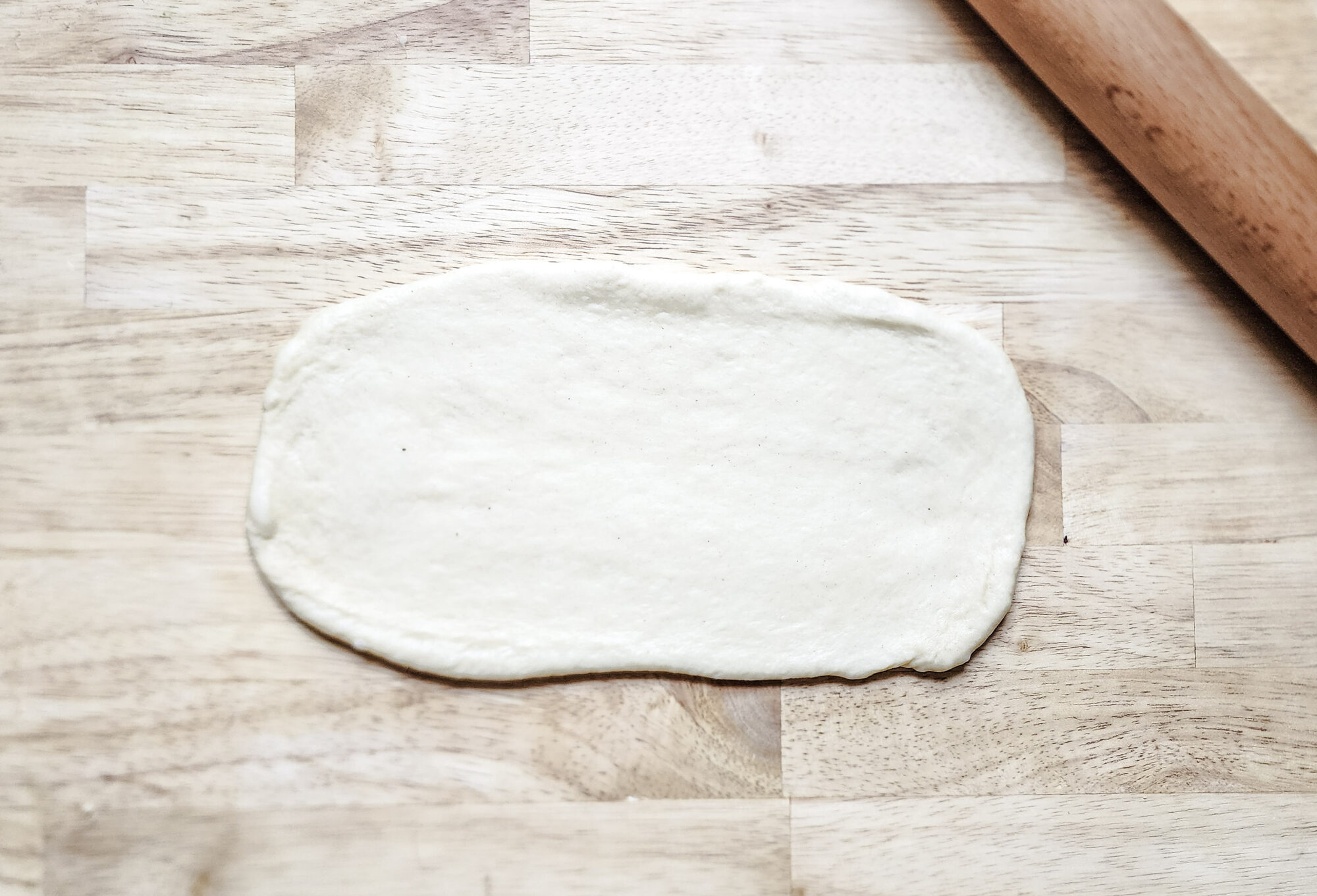 Dough ball rolled flat