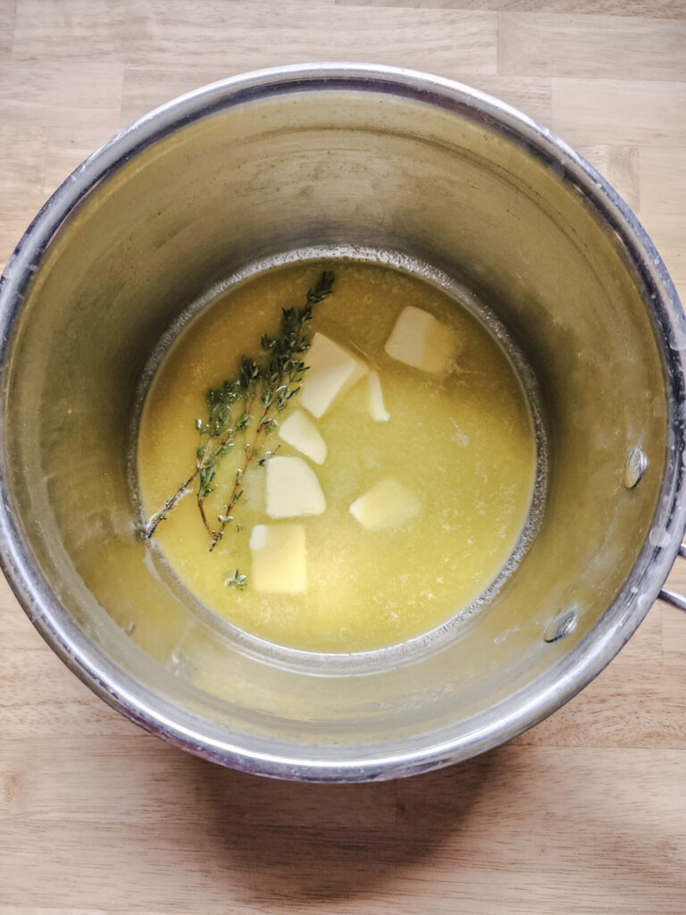 Infusing the butter with fresh thyme sprigs