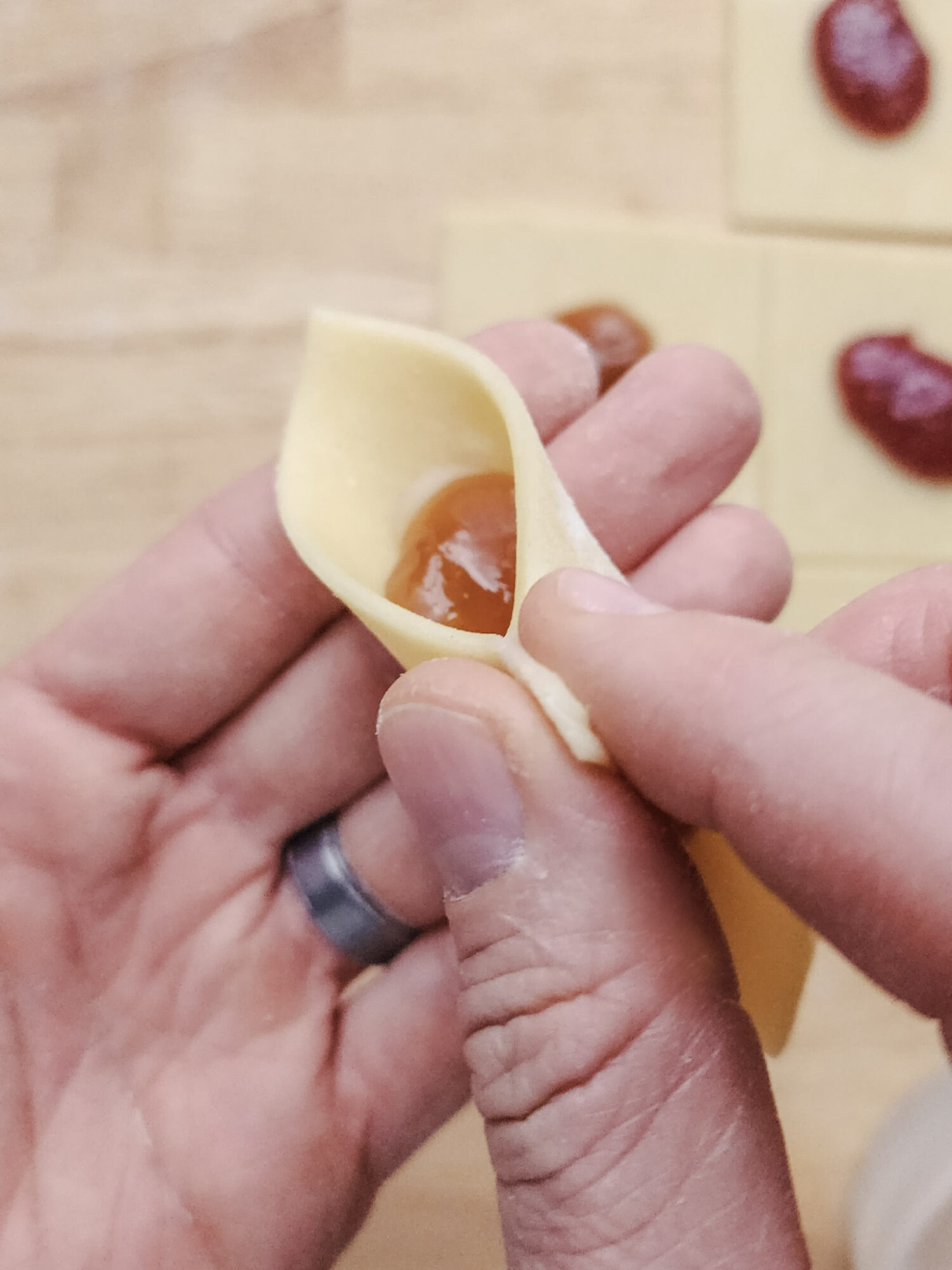 Shaping kolaczki cookies.