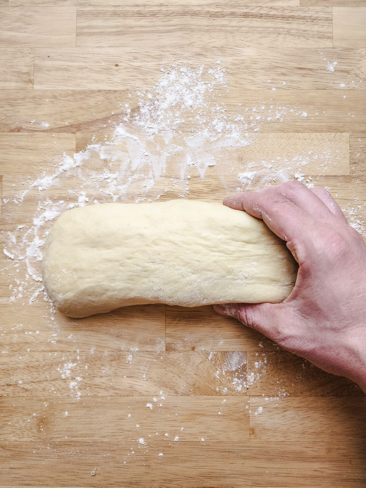 Forming brioche dough into a log