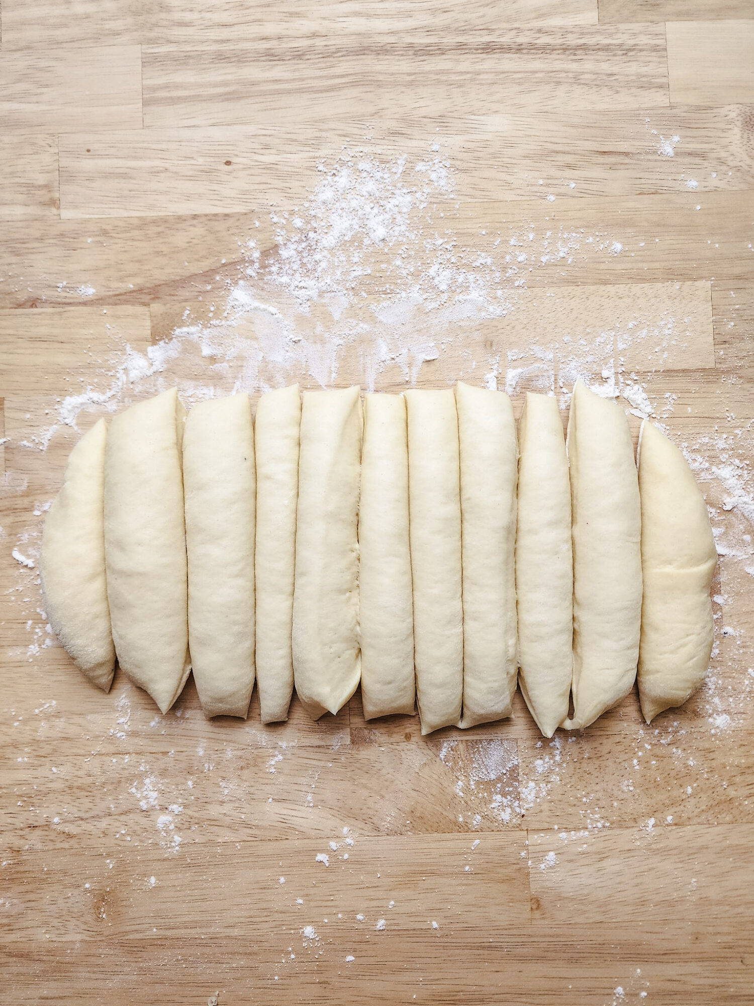 Brioche dough divided into 12 equal pieces