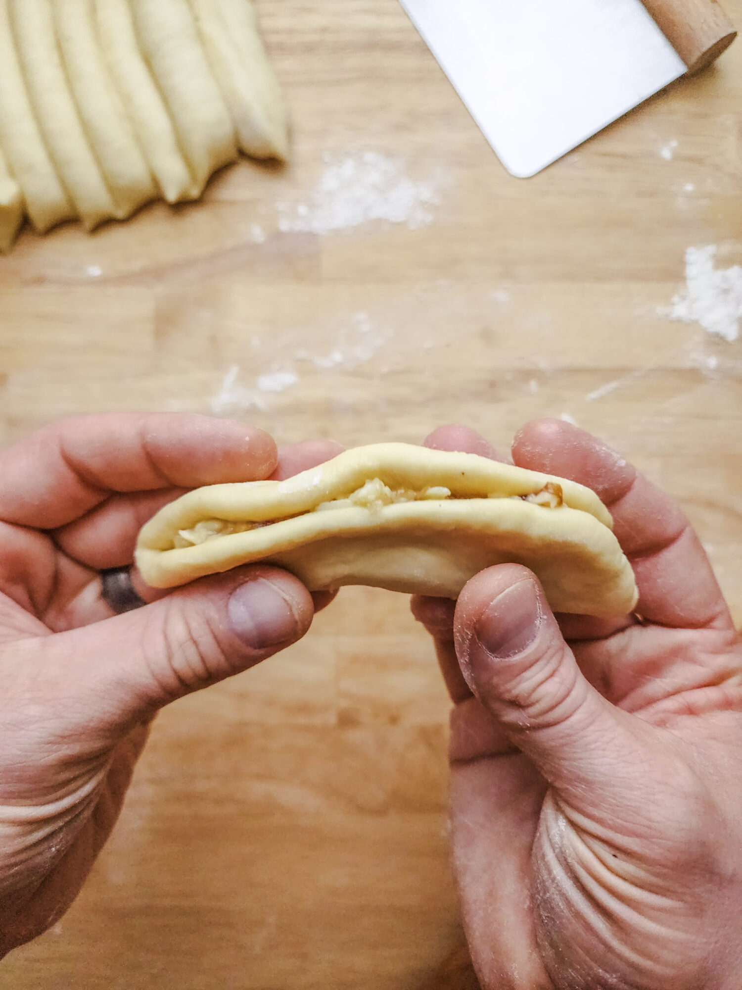 Brioche dough round filled with compound butter folded in half