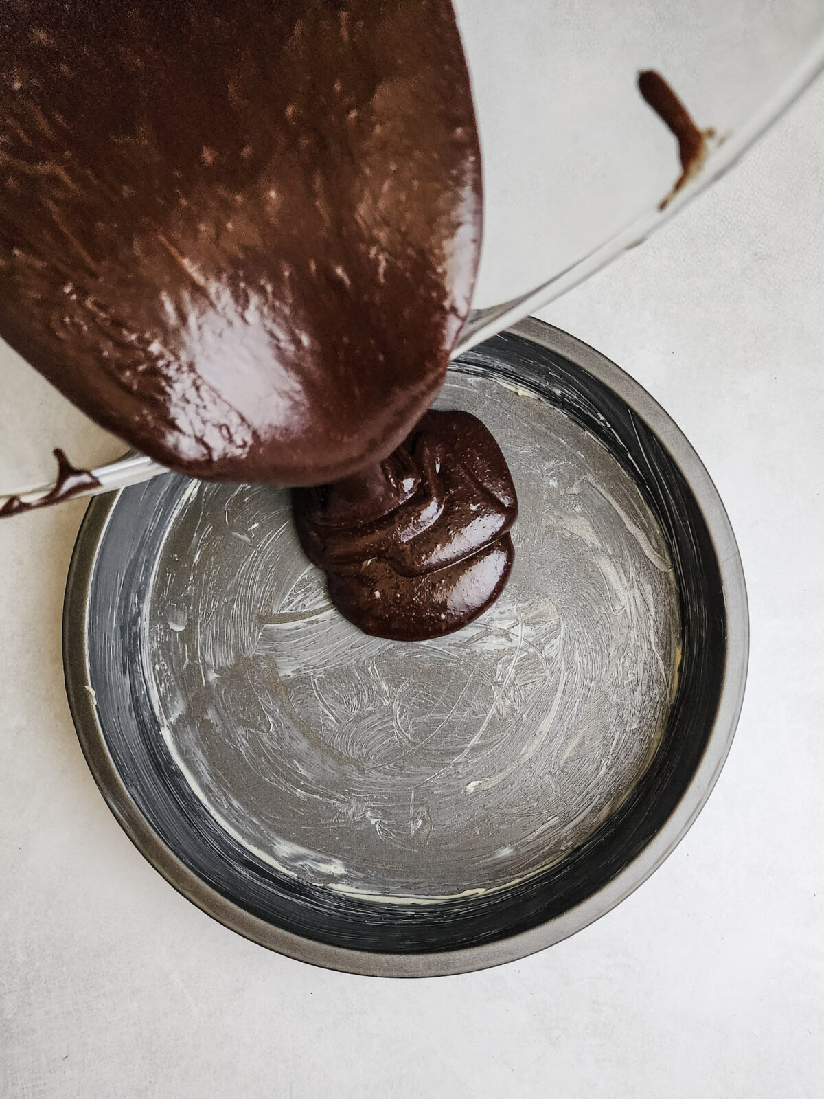 Pour the flourless german chocolate cake into a prepared cake pan.