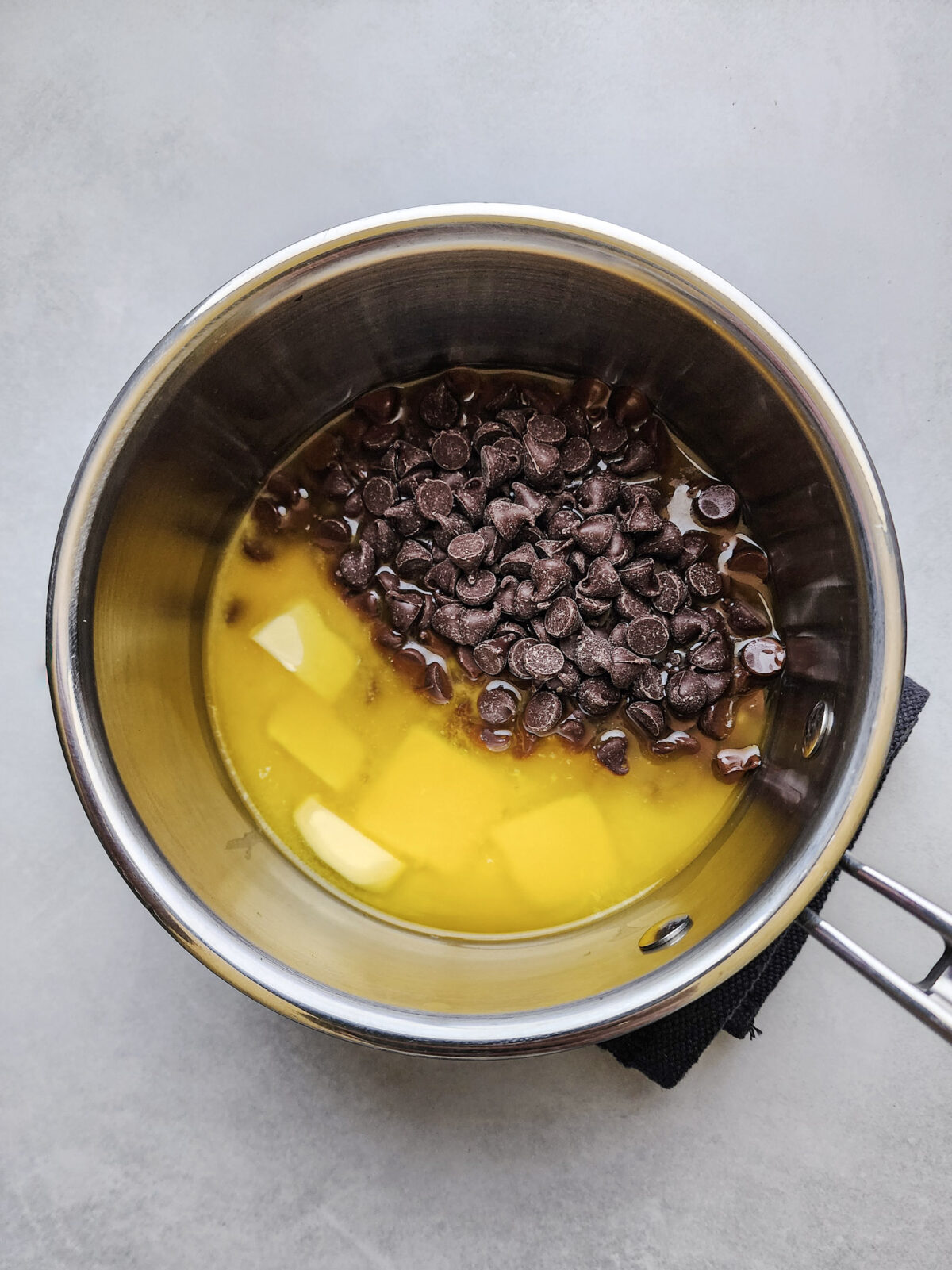 Melting butter and chocolate chips for flourless German Chocolate Cake