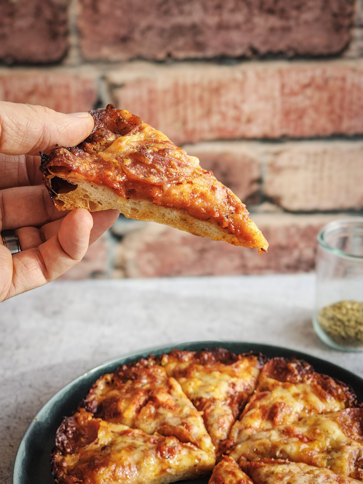 A slice of the Ultimate Homemade Pan Pizza