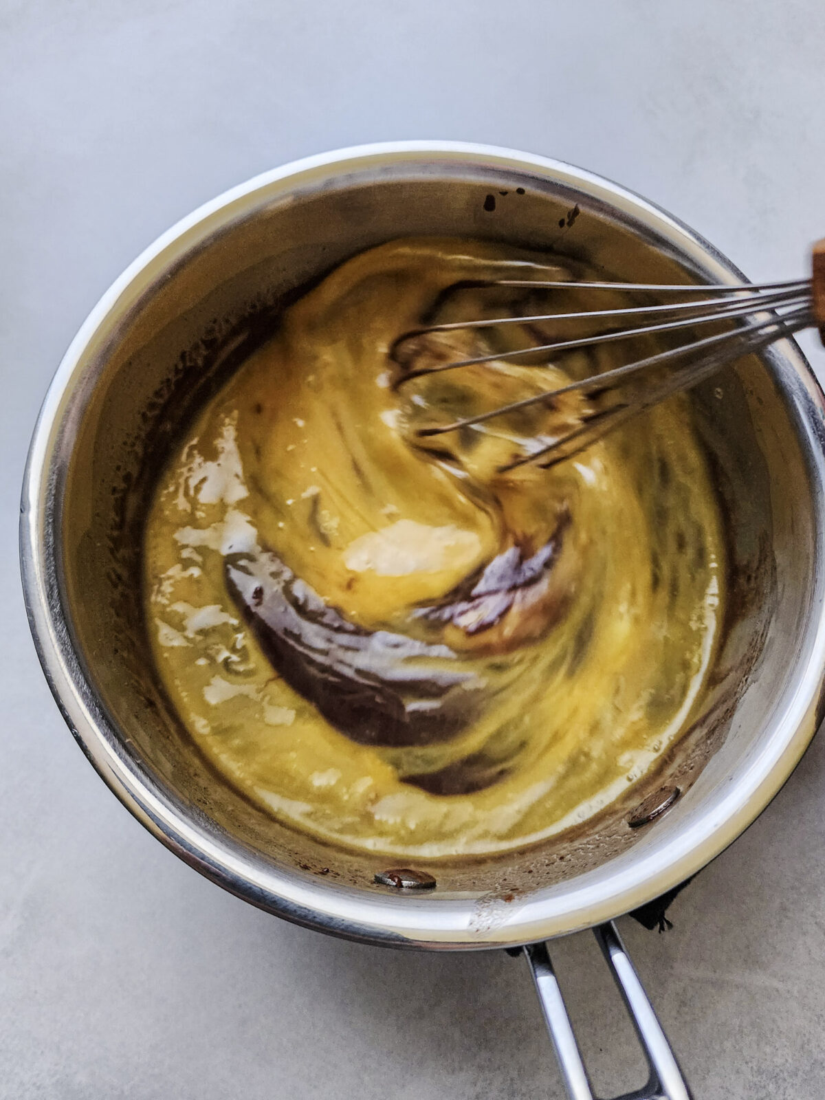 Whisking in egg yolks and vanilla extract for flourless german chocolate cake.