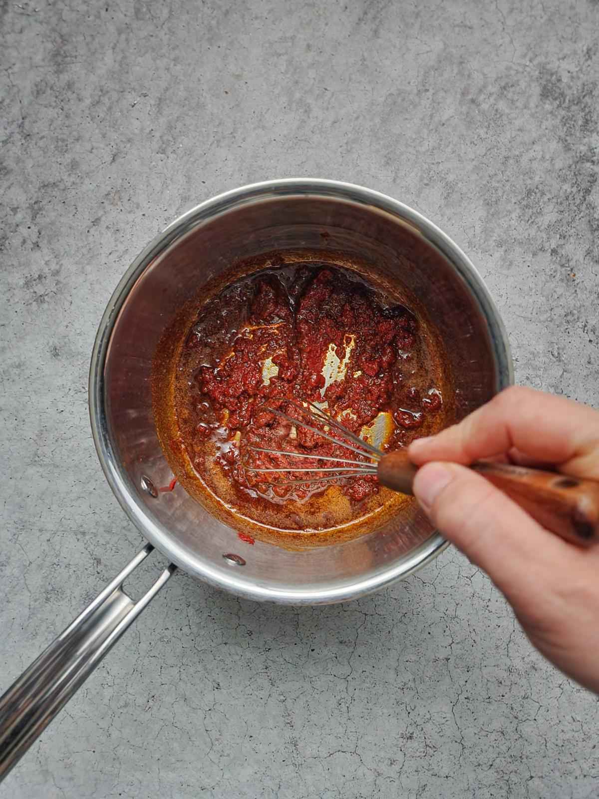 Stir the tomato paste and spices together and cook for an additional minute.