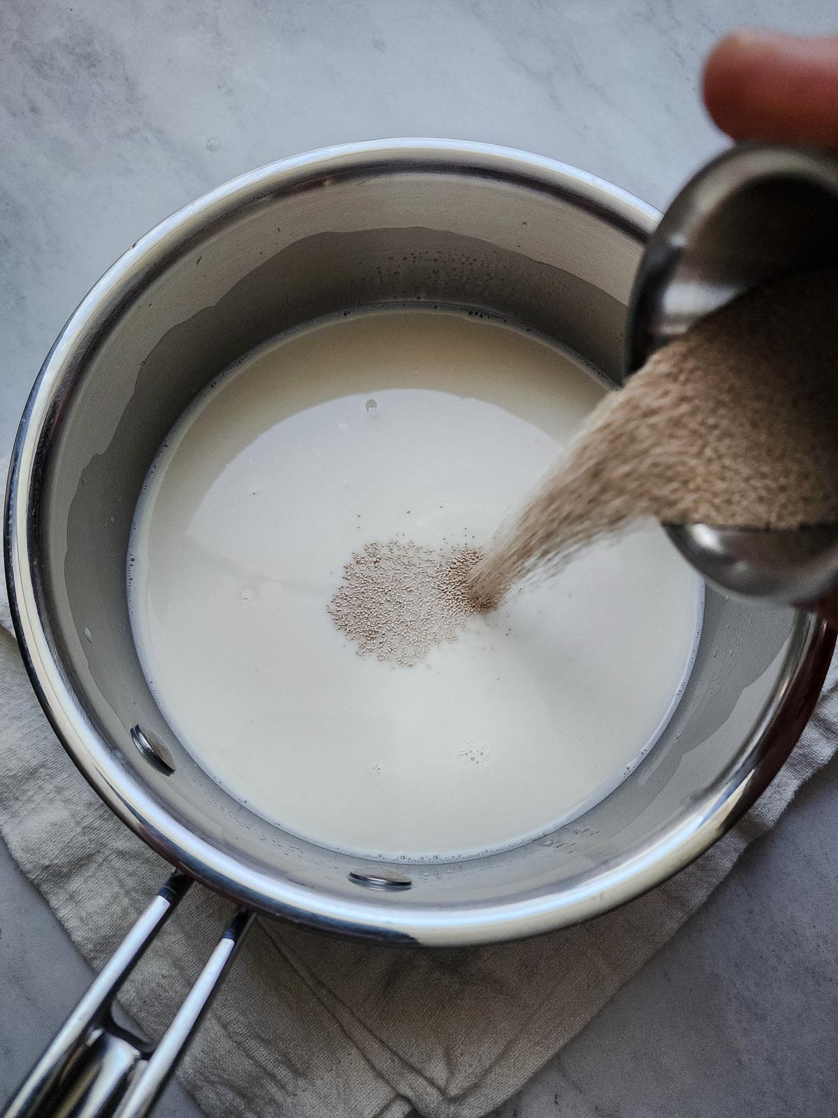 Chai Spiced Cinnamon Rolls Step 1: Combine warm milk, honey, and yeast  and allow to bloom