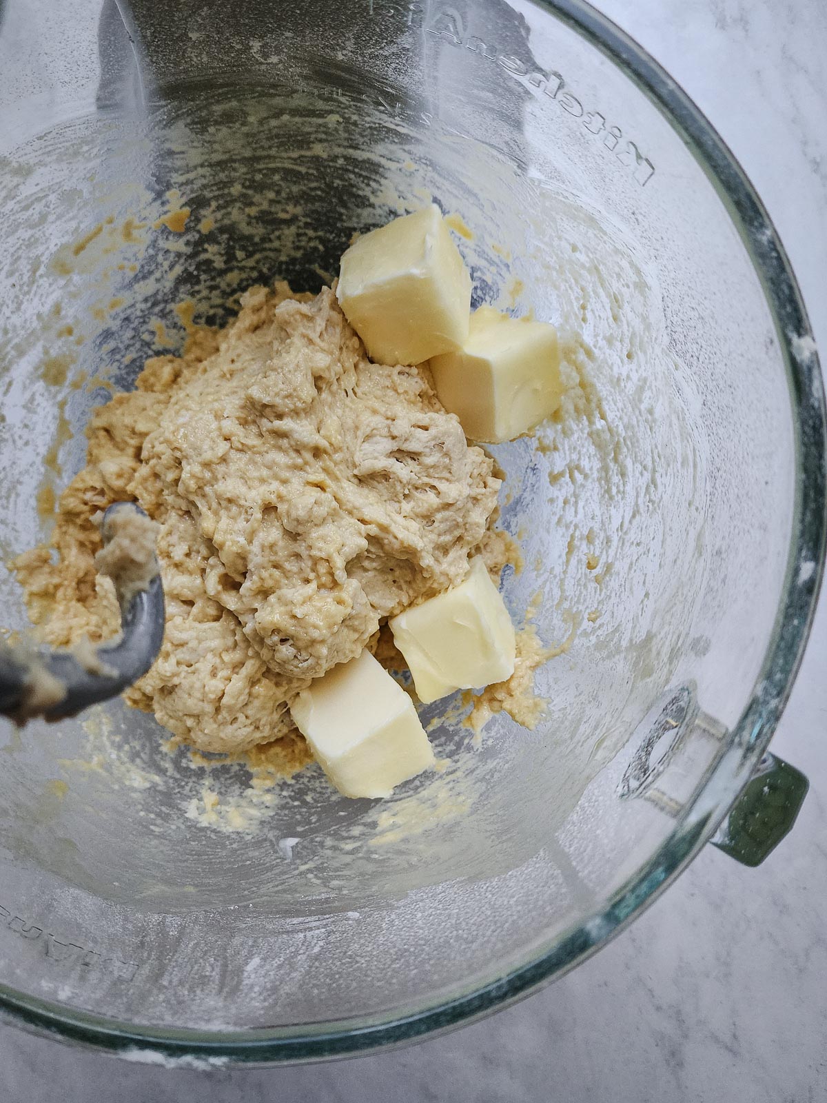 Chai-Spiced Cinnamon Rolls Step 5: Add the softened butter and increase the speed to medium and knead for 8 to 10 minutes until a smooth dough forms and pulls away from the sides of the bowl.