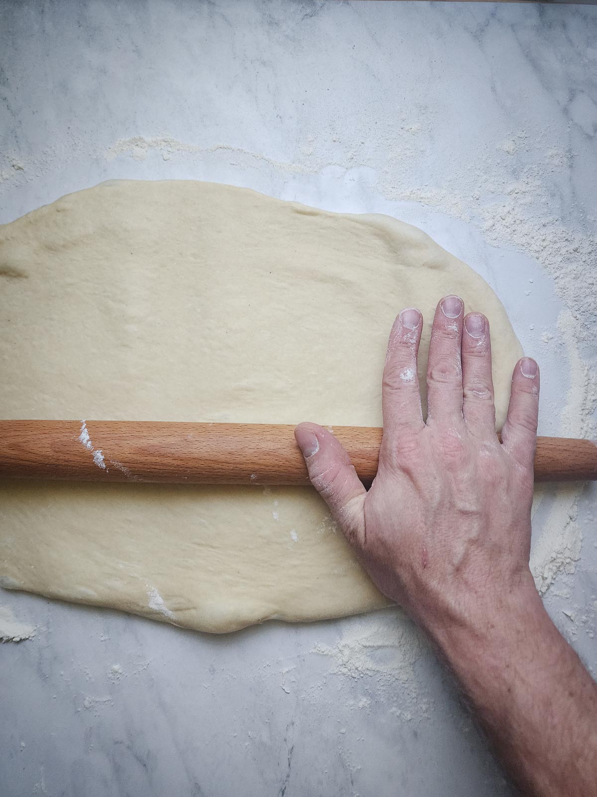 Chai-Spiced Cinnamon Roll - Assembly Step 2: Roll the dough out into a 12-tall by 18-inch wide rectangle.