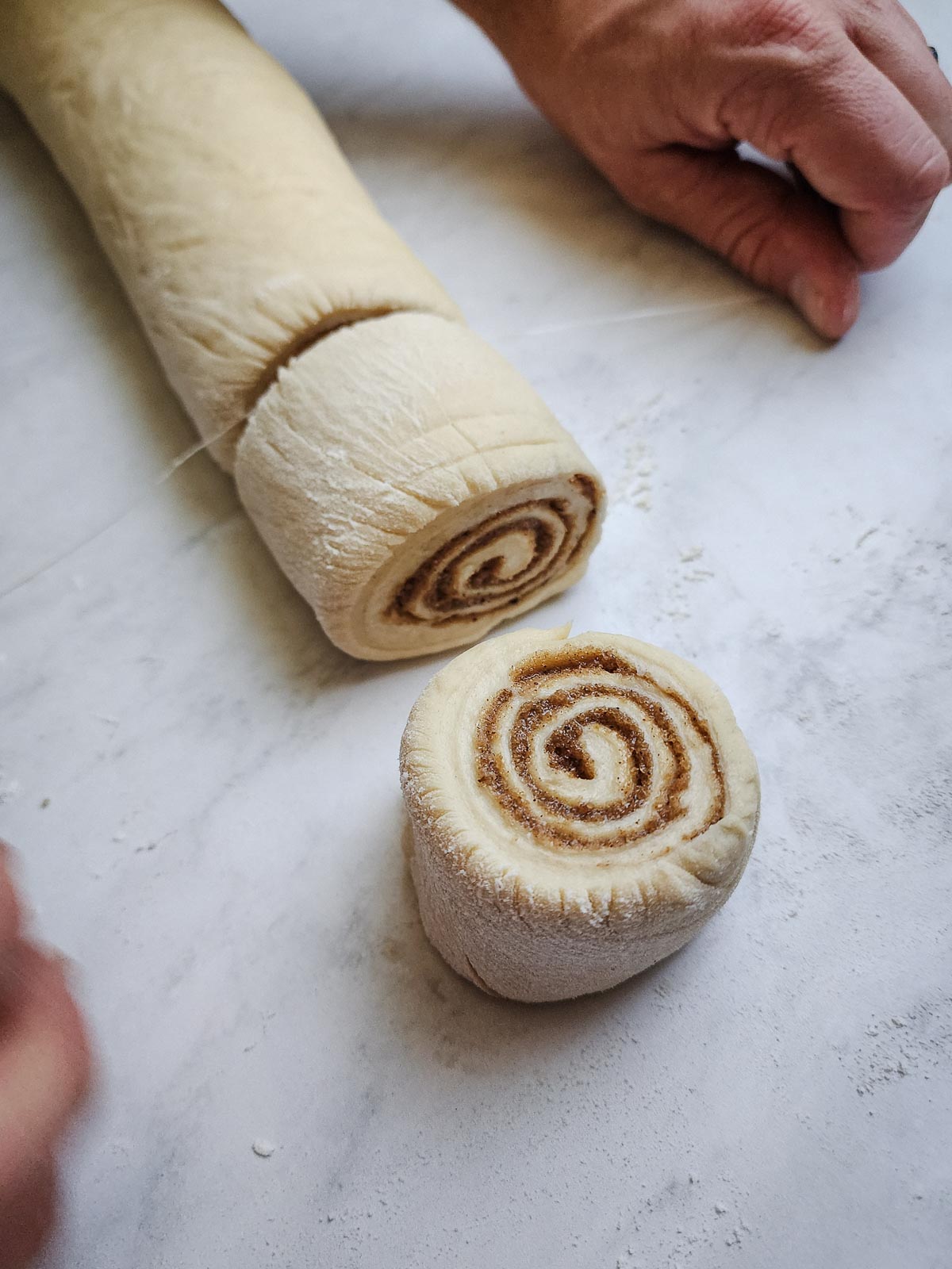 Chai-Spiced Cinnamon Roll - Assembly Step 5: Use a sharp knife or unflavored dental floss to cut the dough log into 2-inch segments.