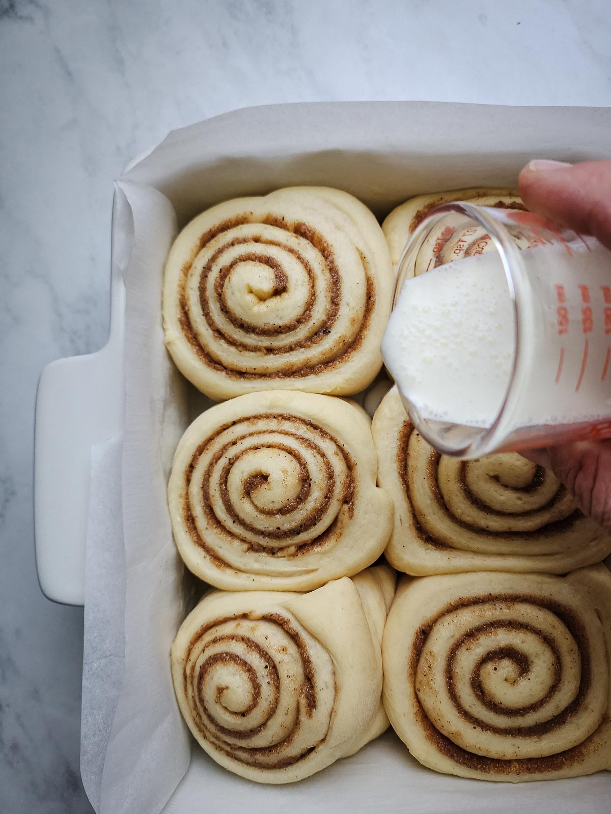 Chai-Spiced Cinnamon Roll - Assembly Step 7: After the second proof (or overnight rest) pour the measured heavy cream between the cinnamon rolls. 