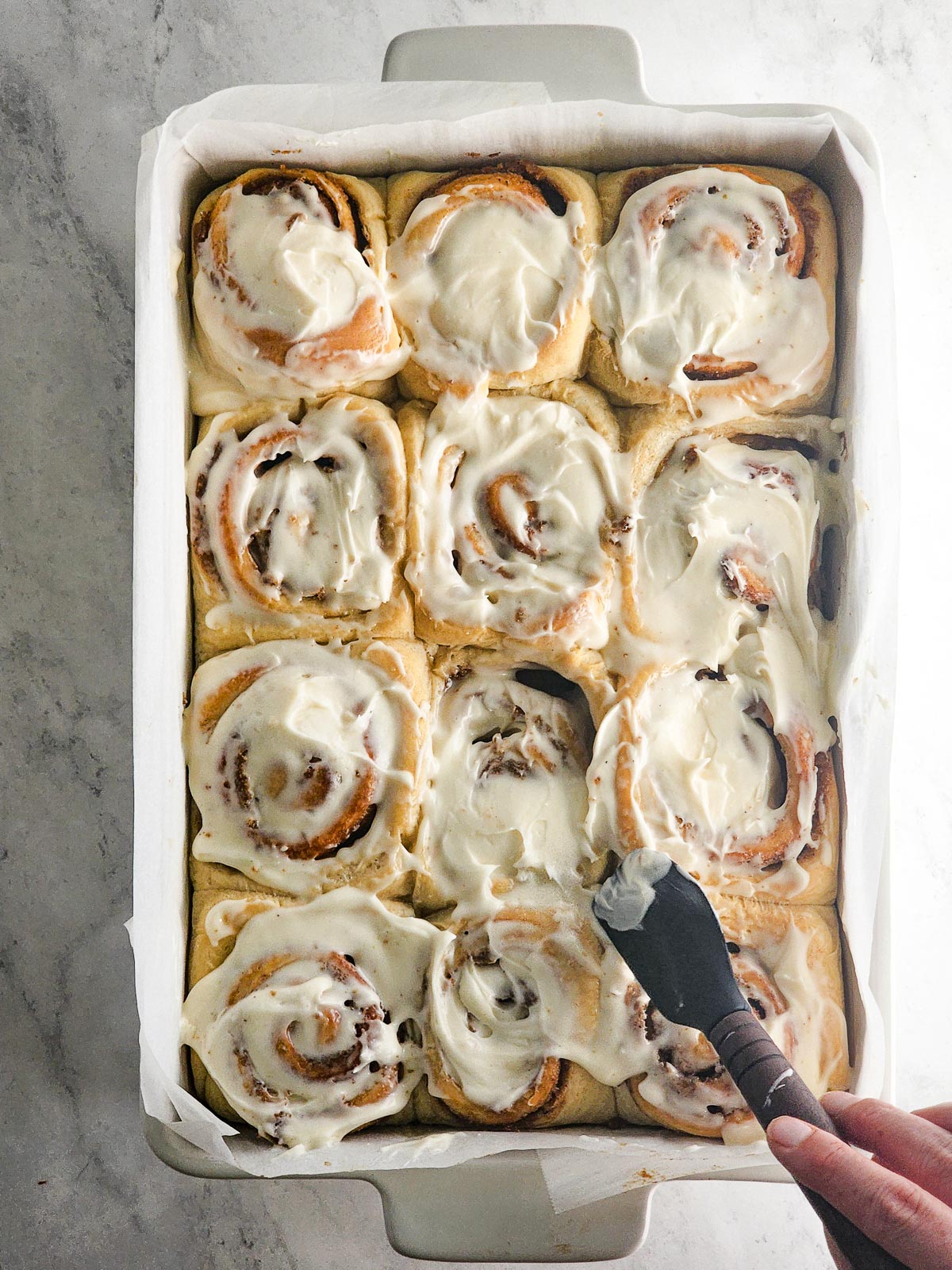 Chai-Spiced Cinnamon Roll - Cream Cheese Frosting Step 2: Spread the cream cheese frosting evenly over the warm (but not hot) cinnamon rolls.