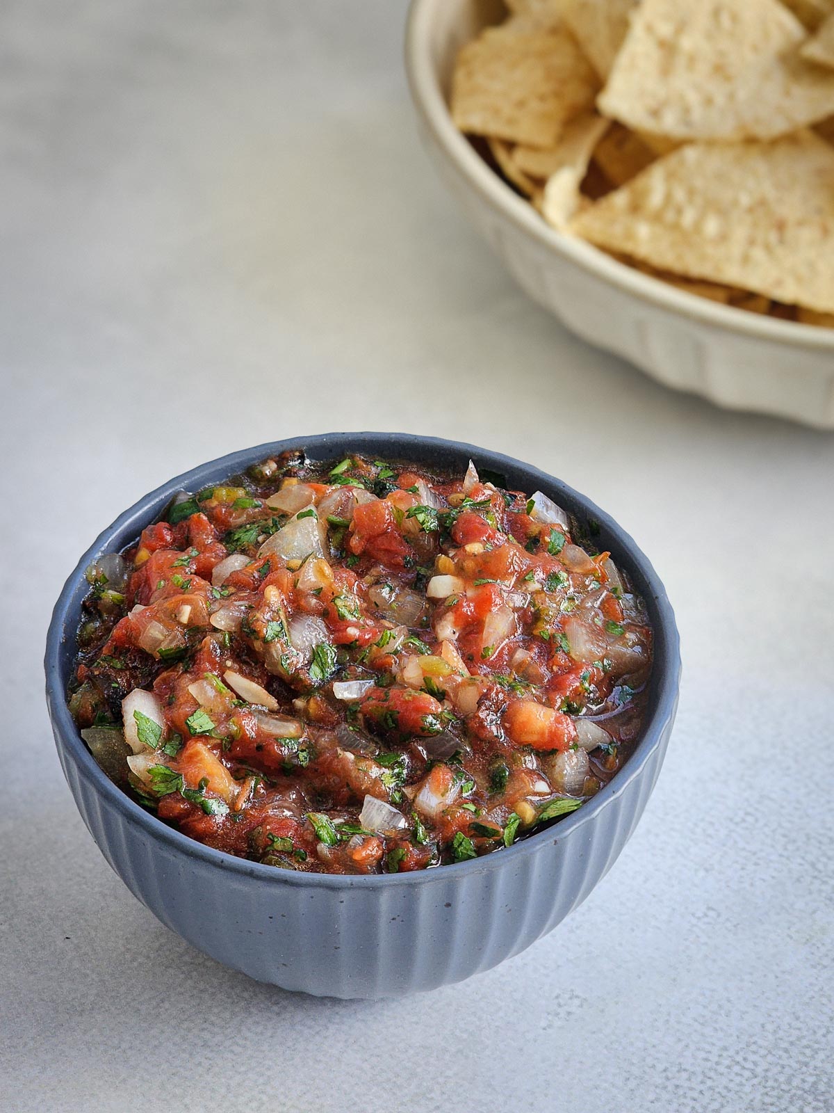 Fire-roasted blowtorch salsa in a bowl served with tortilla chips.