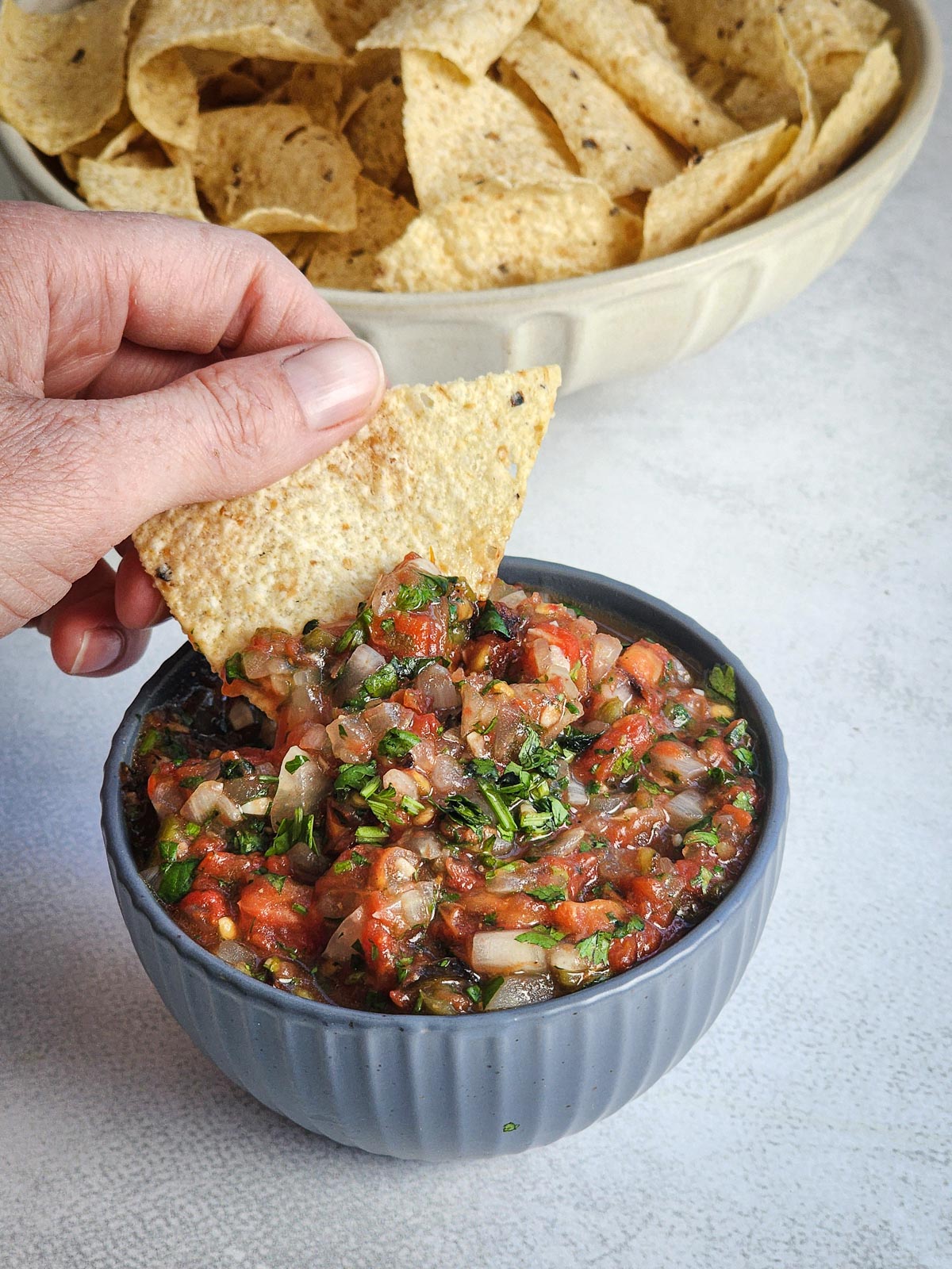 Dipping a chip into Fire-Roasted Blowtorch Salsa.