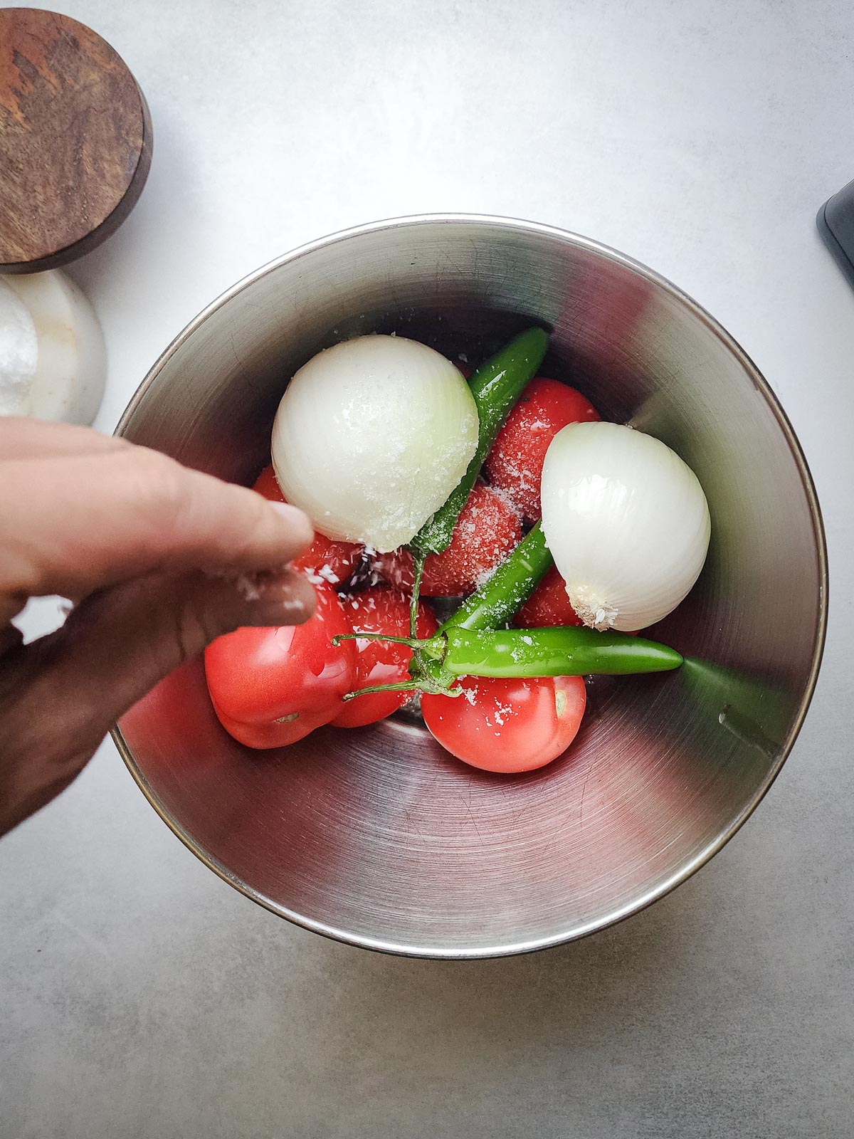 Fire-roasted blowtorch salsa step one: toss the vegetables with oil and salt.