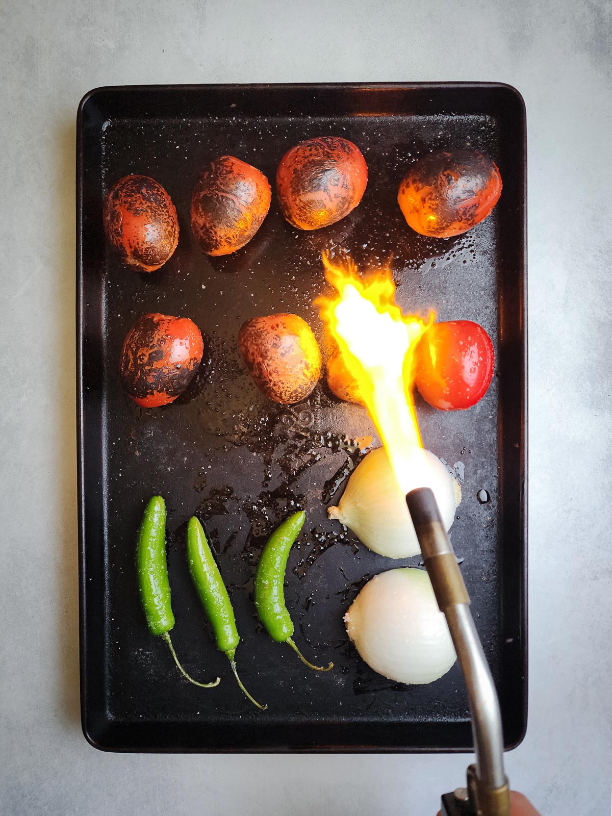 Fire-roasted blowtorch salsa step three: char all sides of the vegetables with a blowtorch (or broiler). 