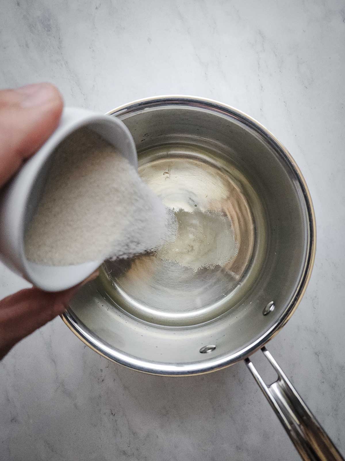 Easy Refrigerator Dill Pickle Slices Step 5: Combine the the water, distilled white vinegar, white wine vinegar, and sugar in a medium saucepan and heat until boiling.