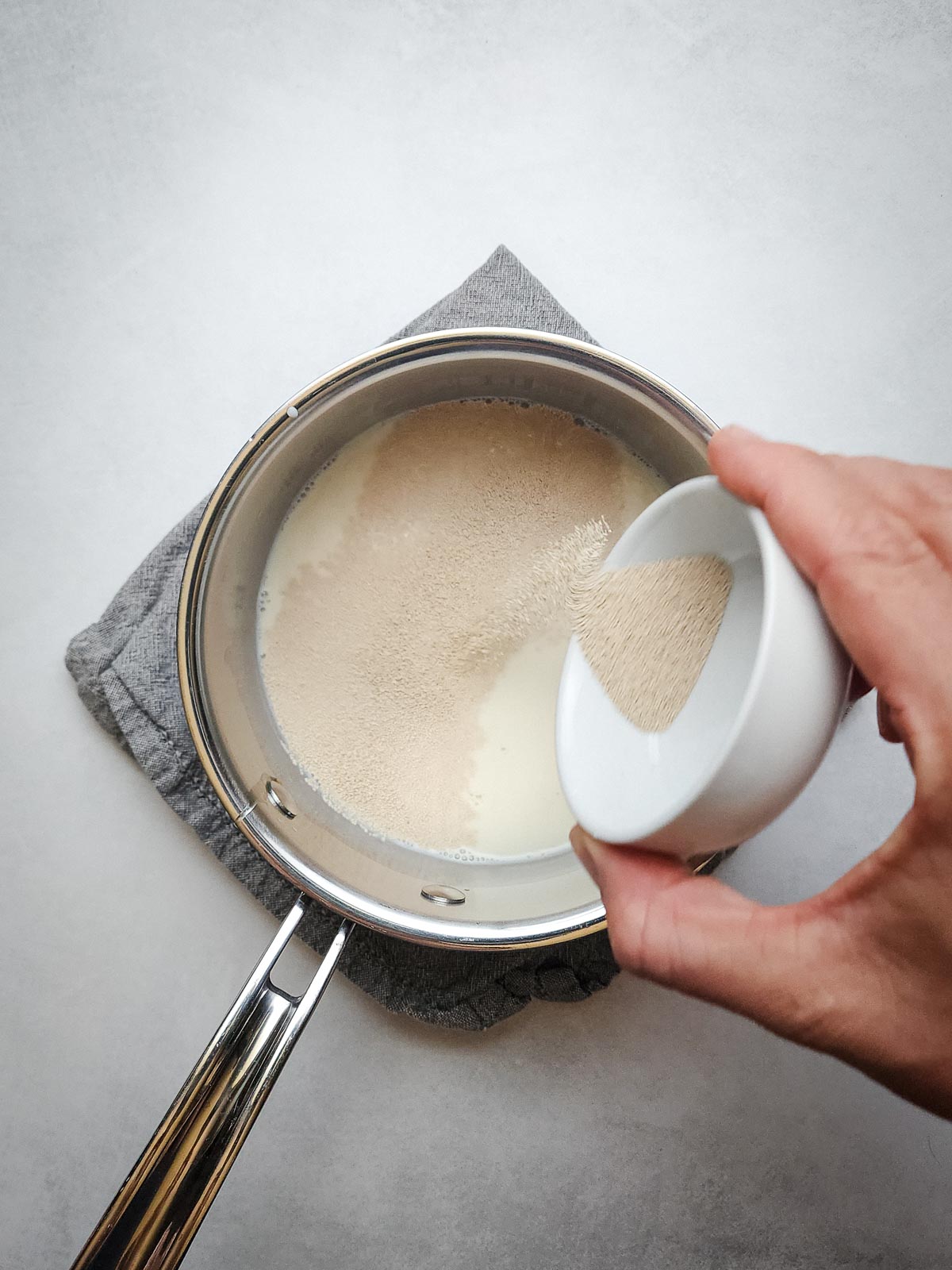 Ultimate Homemade Hamburger Buns Step 1: Combine the warm milk, honey, and yeast and allow to bloom for 5 to 10 minutes.