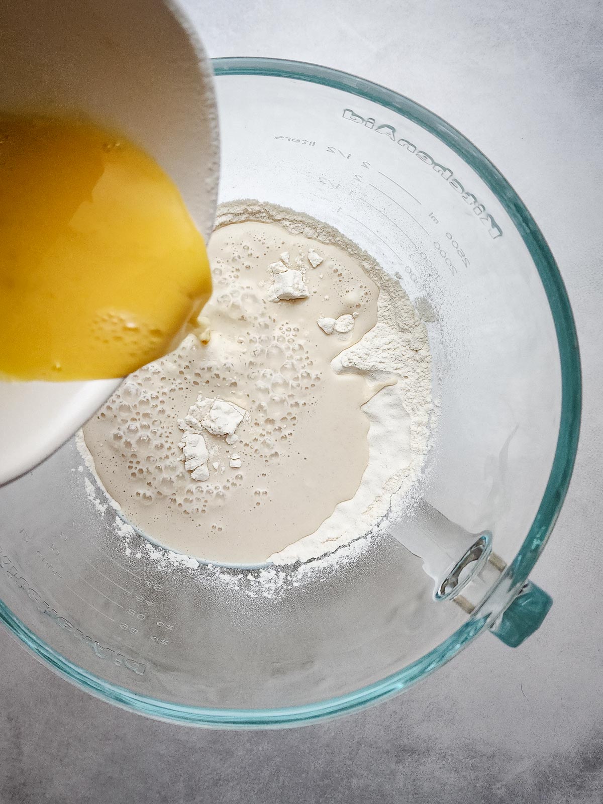 Ultimate Homemade Hamburger Buns Step 3: Add the wet ingredients to the dry, including the egg. Combine on low speed until a shaggy dough forms.