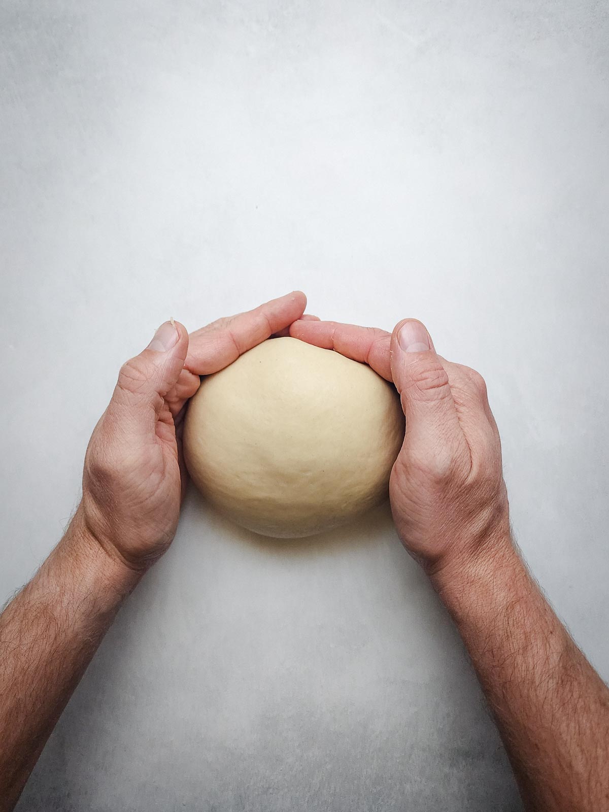 Ultimate Homemade Hamburger Buns Step 5: Turn the dough out onto an un-floured work surface and shape into a ball. Transfer to a bowl and cover.  Proof for 1-hour until doubled in size.