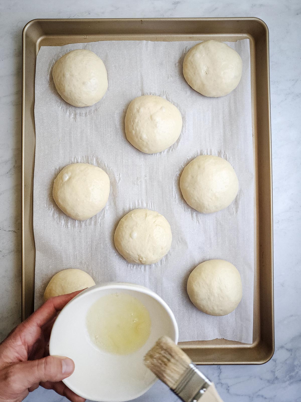 Ultimate Homemade Hamburger Buns Step 10: Uncover the buns and gently brush with egg wash to cover. Optionally, add sesame seeds, poppy sees, or flaky salt as desired.