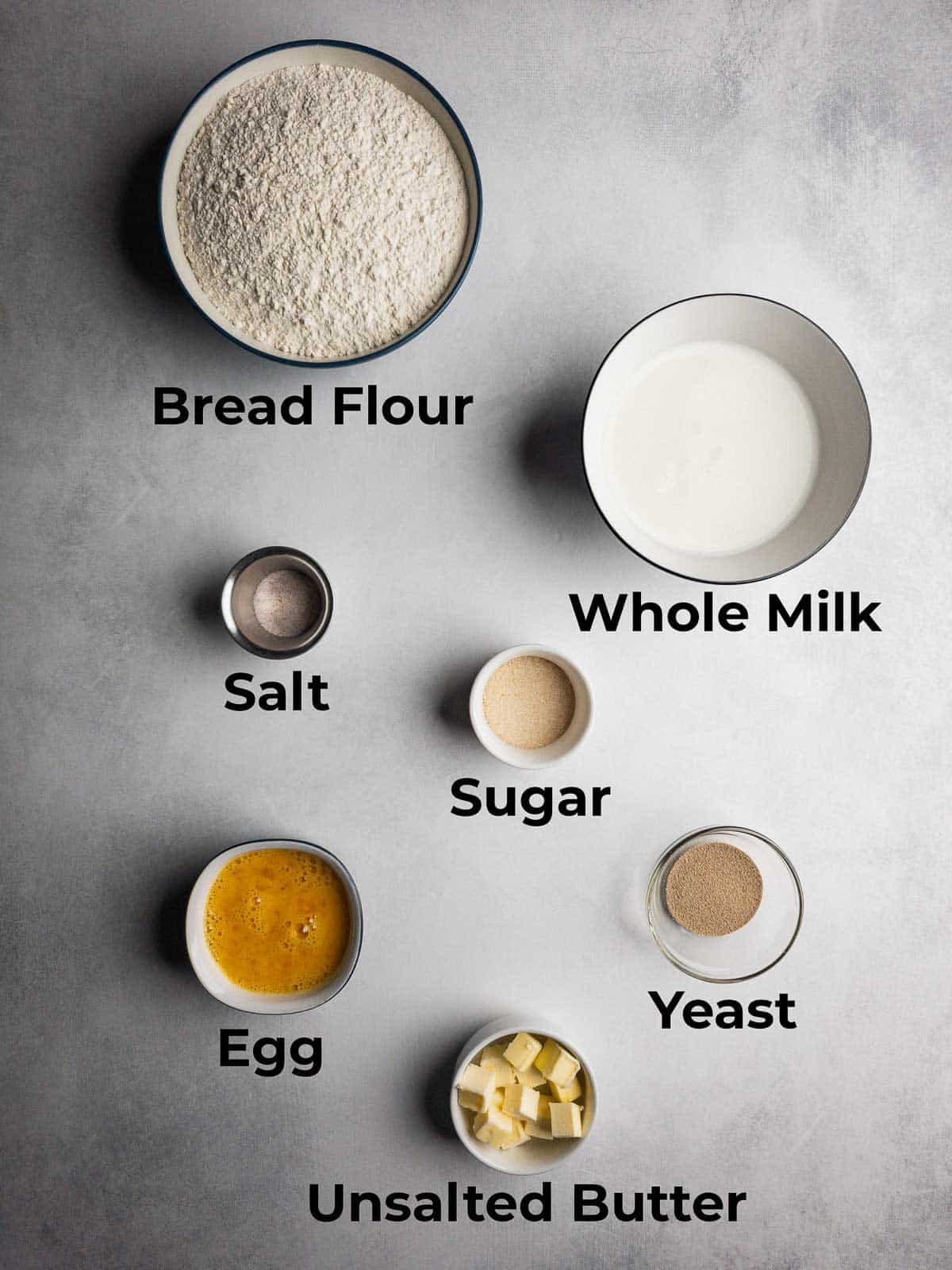 Ingredients for a sub roll recipe displayed on a stone counter.